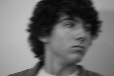 Monochrome close up of Nicholas Fortune's head staring into the distance with lots of directional motion blur